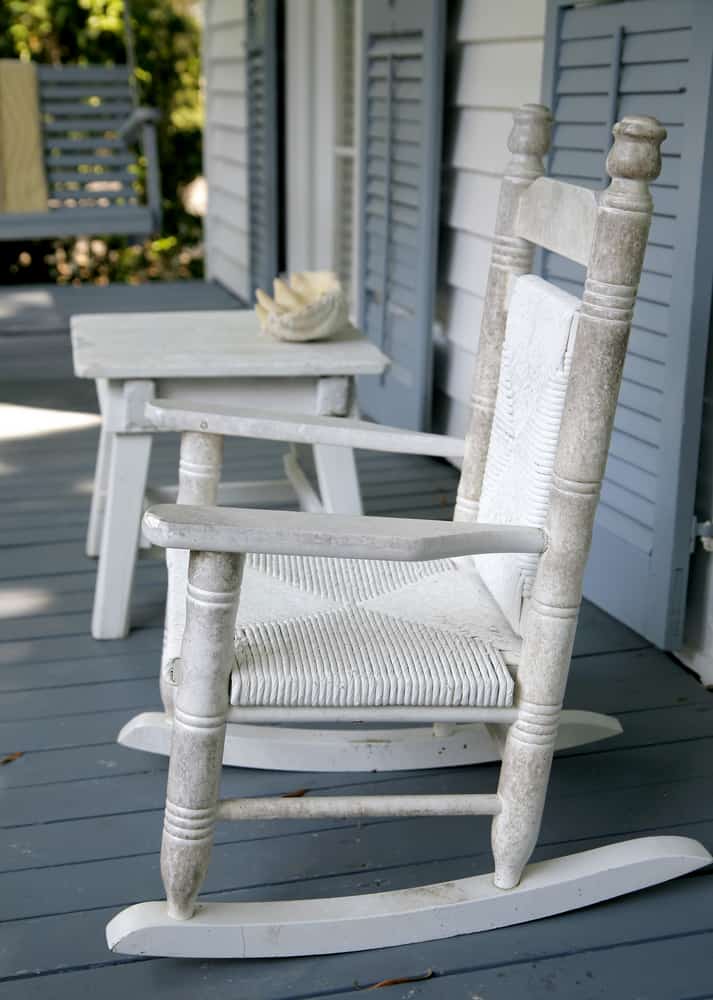 white rocking chair and side table