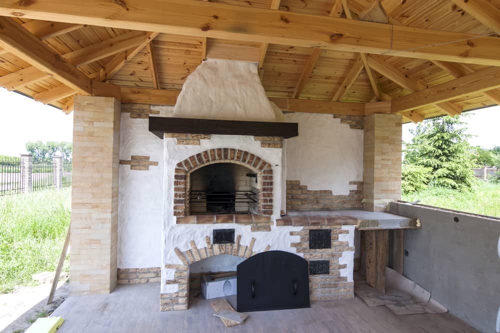 rustic stucco and brick fireplace