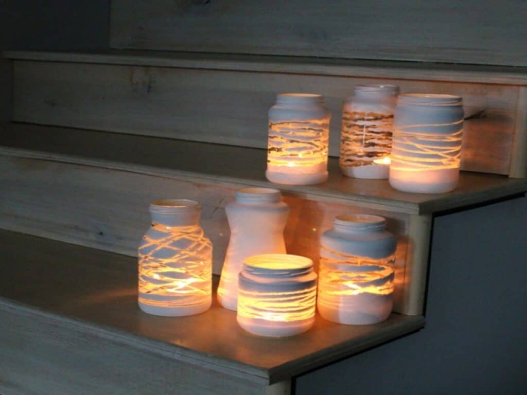 Yarn Wrapped Painted Jars Add a stylish look to your mantle or shelving with these yarn wrapped painted jars. They are simple to make and the result is awesome! Plus, you can even hand these out as gifts too. thesawguy.com